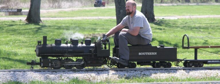 A ride train carrying passengers along the Missouri Live Steamers track